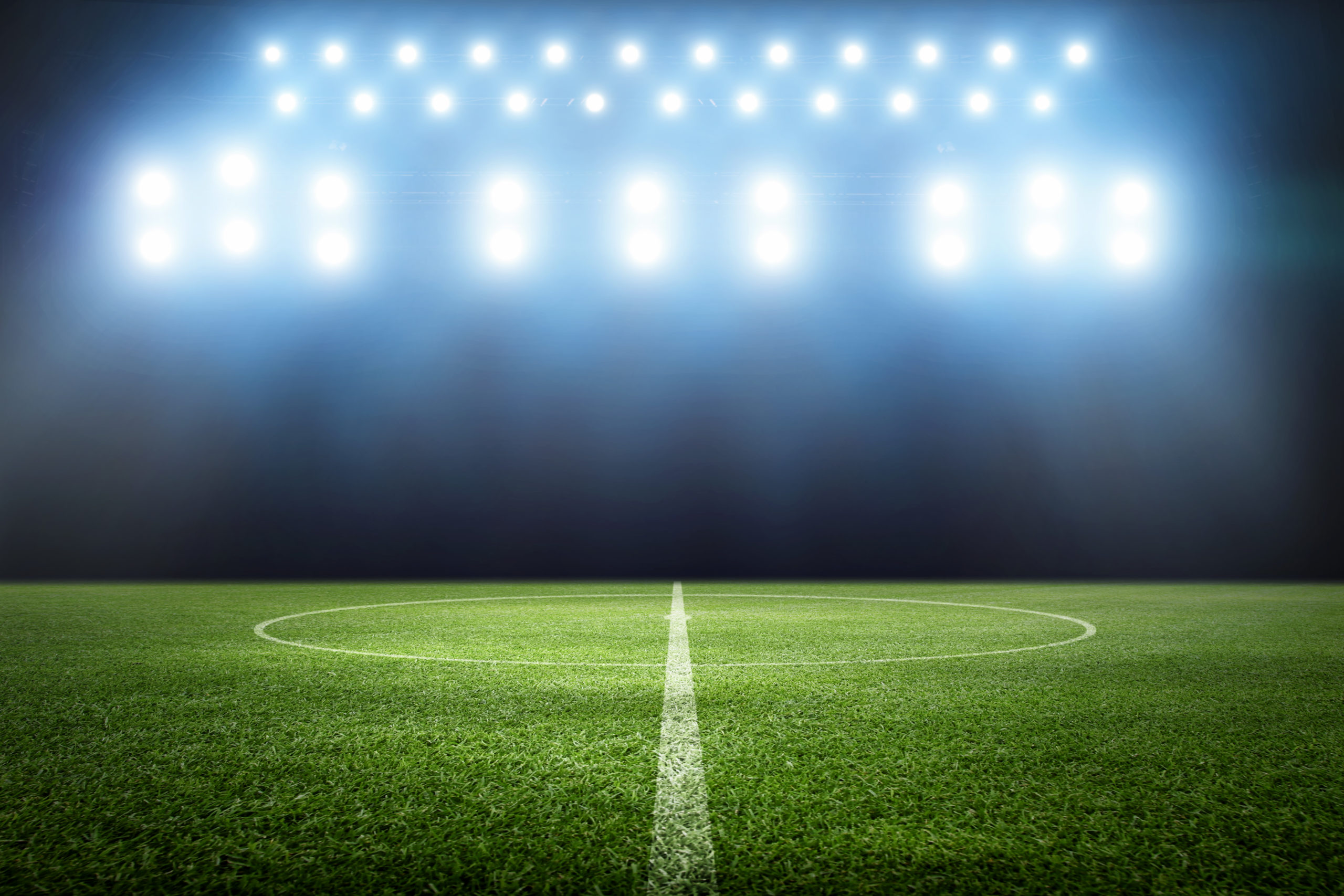 Football stadium, shiny lights, view from field. Soccer concept
